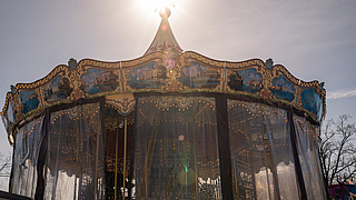 Schaustellergehilfe verschließt Venetian Carousel mit Plane
