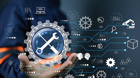 Aus einer Handfläche erscheint eine Mindmap mit Werkezugen, Zahnrädern und Symbolen für die Wartung von Maschinen.